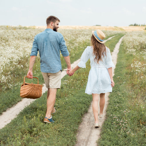 Man and woman going for a picnic holding hands