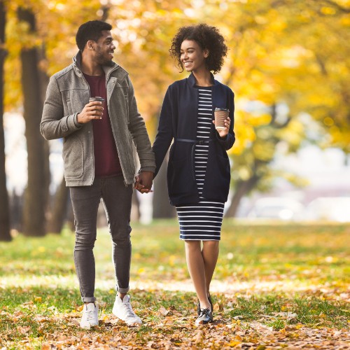 Man and woman holding hands smiling