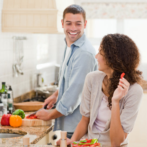 Man and woman cooking and chatting in the kitchen