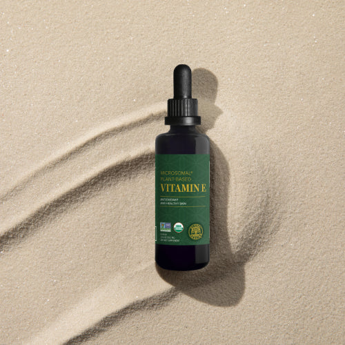 Organic Microsomal Vitamin E Bottle in sand