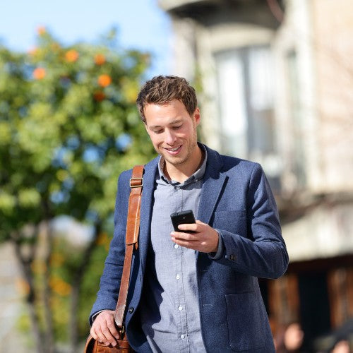 Man smiling looking at his phone