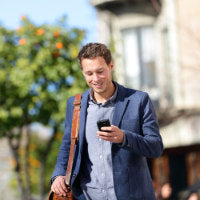 Man walking looking at his phone