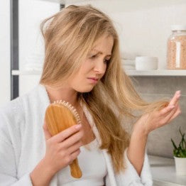 Woman looking worried about losing her hair