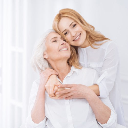 Older woman and younger woman hugging