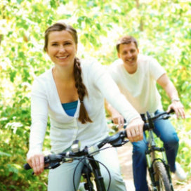 Couple cycling in the woods