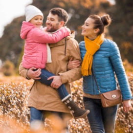 Man, woman and young child walking