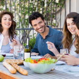 A group of men and women having dinner