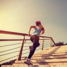 Woman running up some steps