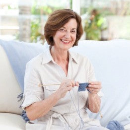Smiling older lady knitting