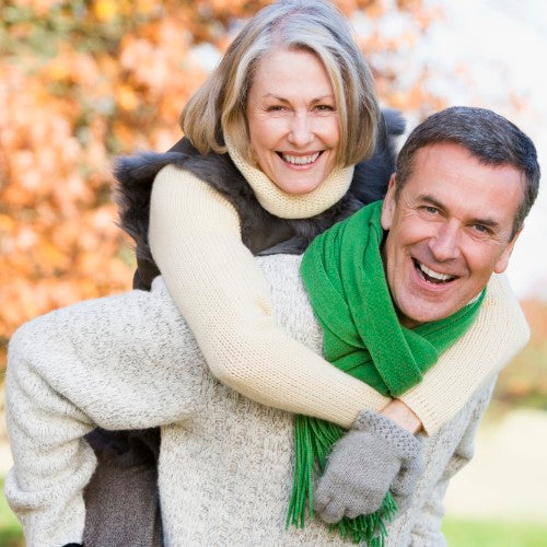 Man giving a woman a donkey back and smiling