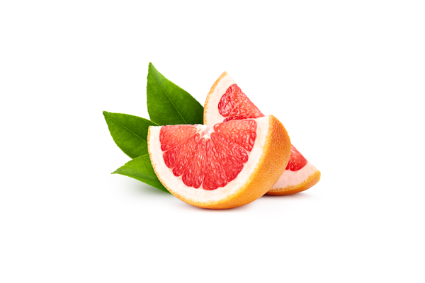 Sliced grapefruit with green leaves on a white background