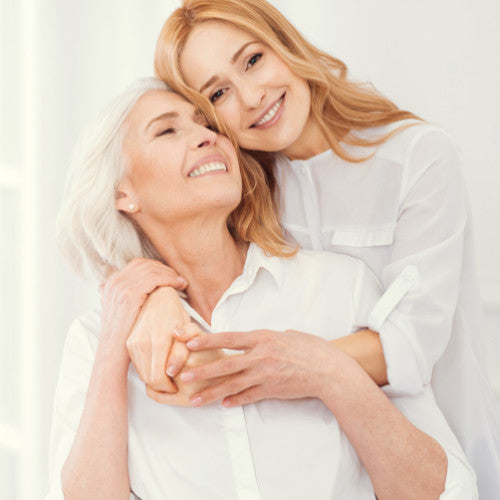 Older woman and younger woman hugging