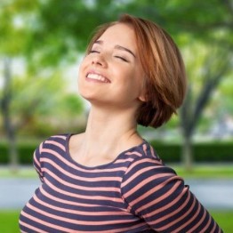 Woman breathing in and smiling