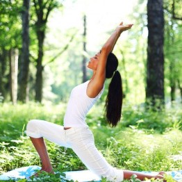 Woman doing a yoga pose in the woods